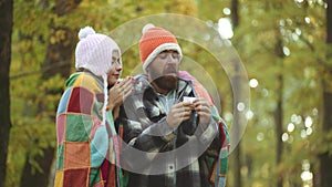 Young couple with handkerchief. Nose wiper near autumn tree. Napkin sneezing in the autumn yellow park.