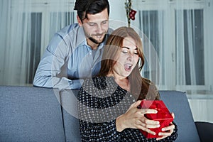 Young couple is happy with gift for christmas