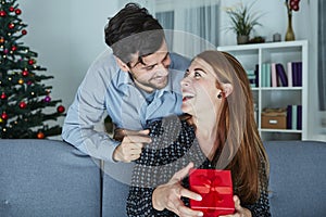 Young couple is happy with gift for christmas