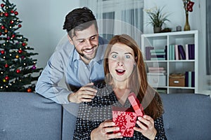 Young couple is happy with gift for christmas