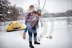 Young couple has fun during winter hike.