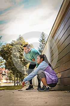 Young couple have break after running.