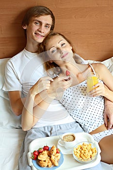 Young couple have breakfast in bed