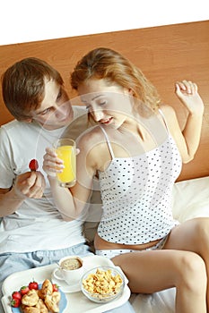 Young couple have breakfast in bed