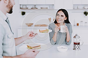 Young Couple Have Breakfast in Modern Kitchen.