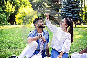 Young couple have fun on picnic in the park.