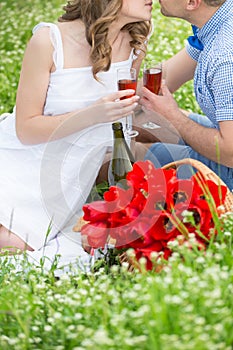 Young couple have picnic with red wine