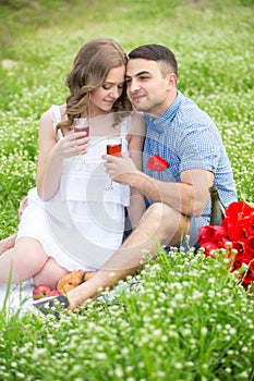 Young couple have picnic with red wine