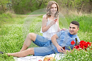 Young couple have picnic with red wine