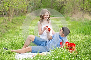 Young couple have picnic with red wine