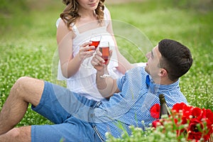 Young couple have picnic with red wine