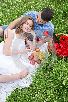 Young couple have picnic with red wine