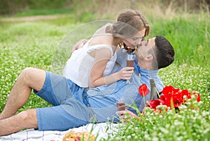 Young couple have picnic with red wine