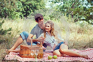 Young couple have a rest on picnic, holding hands