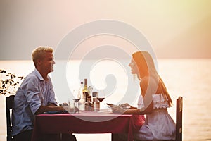 Young couple have romantic evening on sea beach