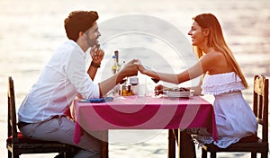 Young couple have romantic evening on sea beach