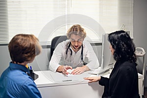 A young couple having a consultation with a doctor in a hospital