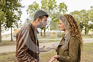 Young couple having a debate in the public park