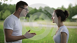 Young couple having fight in summer park