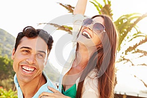 Young Couple Having Fun On Beach Holiday Together