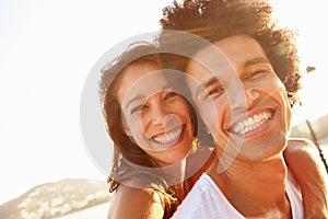 Young Couple Having Fun On Beach Holiday Together