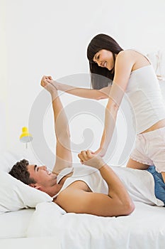 Young couple having fun on bed