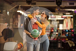 Young couple having fun in bowling alley.