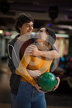 Young couple having fun in bowling alley