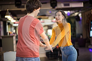 Young couple having fun in bowling alley