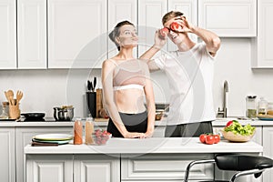 young couple having fun while cooking pasta