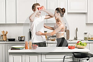 young couple having fun while cooking pasta