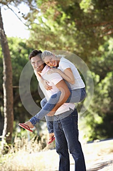 Young Couple Having Fun On Countryside Walk