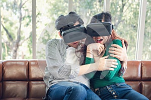 Young Couple Having Fun Exciting While Watching Video Via Virtual Reality Together. Couple Love Enjoying With Electronic VR Video