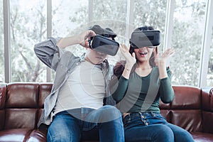 Young Couple Having Fun Exciting While Watching Video Via Virtual Reality Together. Couple Love Enjoying With Electronic VR Video