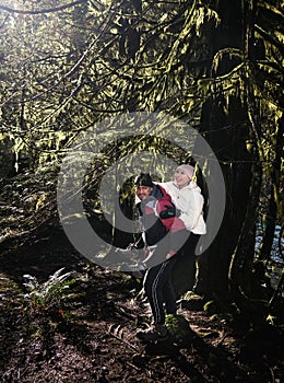Young couple having fun in forest.