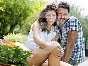 Young couple having fun in a greenhouse