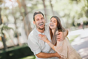 Young couple having fun and laughing together outdoors