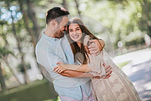 Young couple having fun and laughing together outdoors, selective focus