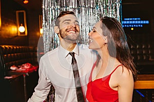 Young couple having fun in the night club. Man and woman in the pub