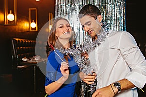 Young couple having fun in the night club. Man and woman in the pub