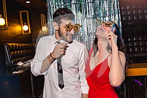 Young couple having fun in the night club. Man and woman in the pub