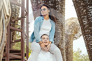 Young Couple having fun outdoors at sunny summer day