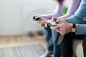 Young couple having fun playing video games