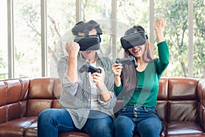 Young Couple Having Fun While Playing Virtual Reality Game Together in Their Home. Couple Love Having Enjoyment With Electronic VR