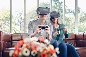 Young Couple Having Fun While Playing Virtual Reality Game Together in Their Home. Couple Love Having Enjoyment With Electronic VR