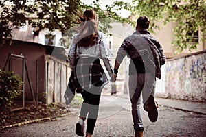 Happy couple running outdoor.