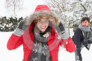 Young couple having fun in the snow