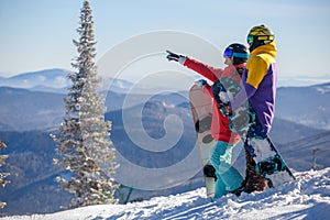 Young couple having fun with snowboards