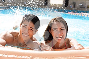 Young Couple having fun in swimming pool