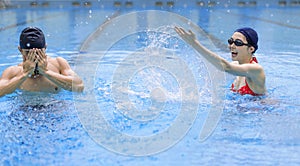 Young couple having fun in swimming pool at summertime